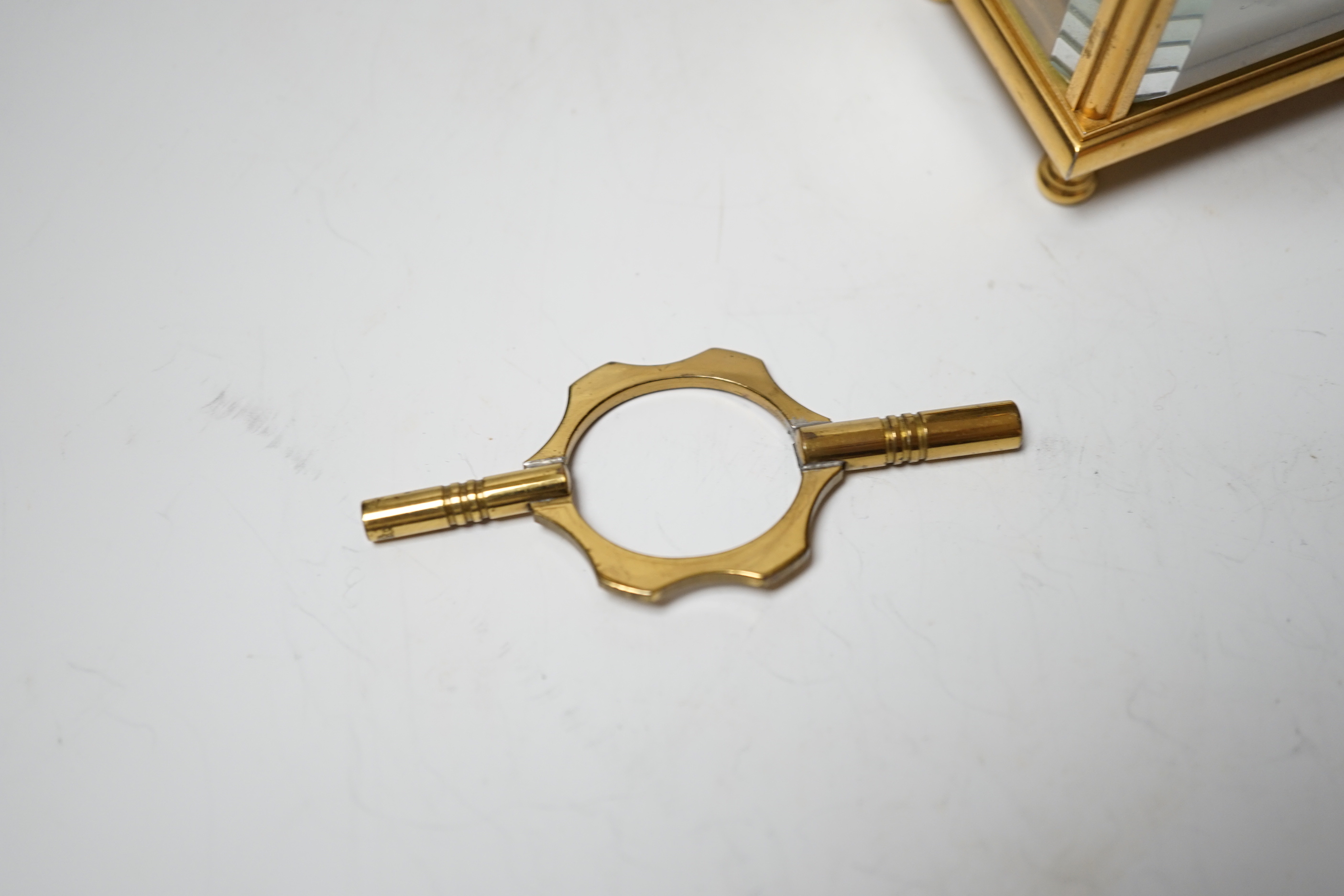 An Angelus miniature brass cased carriage clock with key, 9cm
